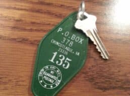 A green key tag labeled "P.O. BOX 378" with a key attached.