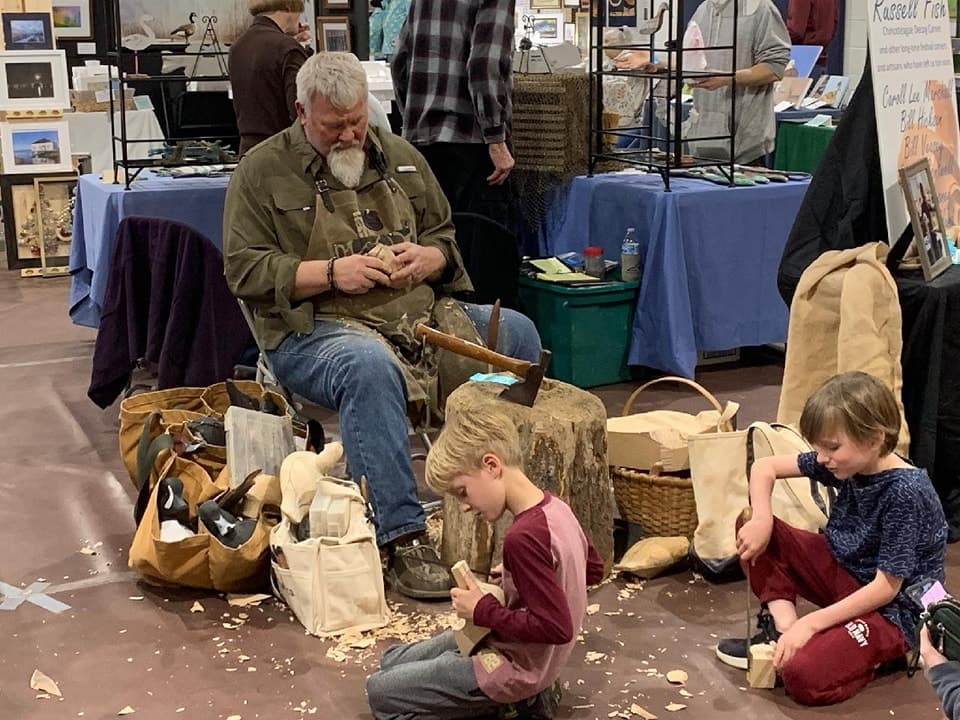 Refuge Inn owner Arthur Leonard gives a decoy carving demonstration to two young visitors at the Easter Decoy and Art Festival Refuge Inn owner Arthur Leonard gives a decoy carving demonstration to two young visitors at the Easter Decoy and Art Festival